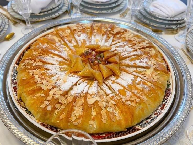 Moroccan pastilla topped with almonds and icing sugar