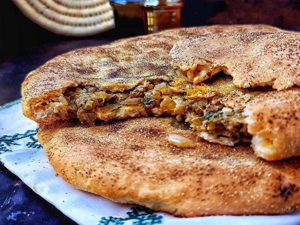 Moroccan madfouna stuffed bread cut open to show the spiced filling